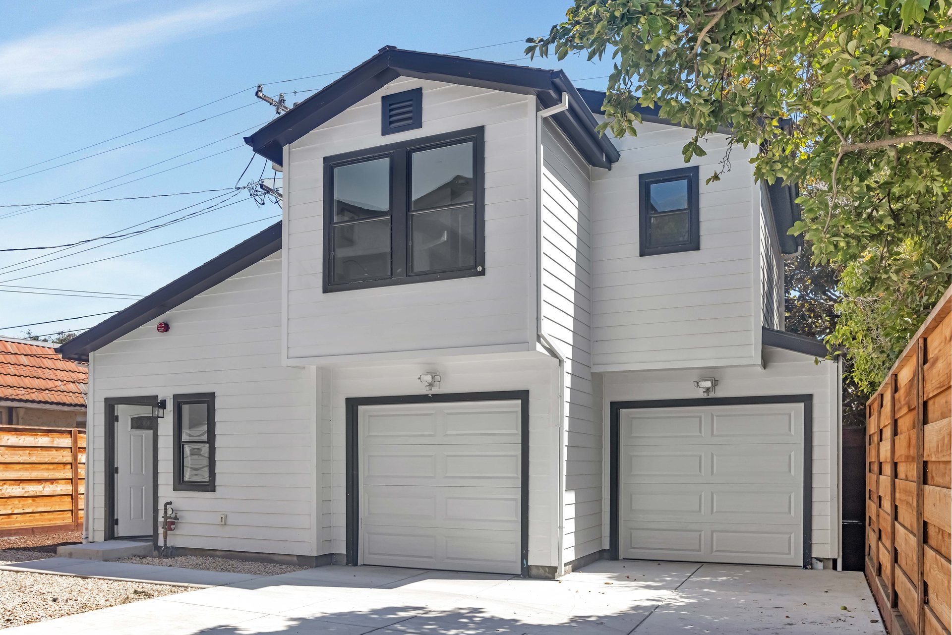 Detached two-story unit with living space above a two-car garage