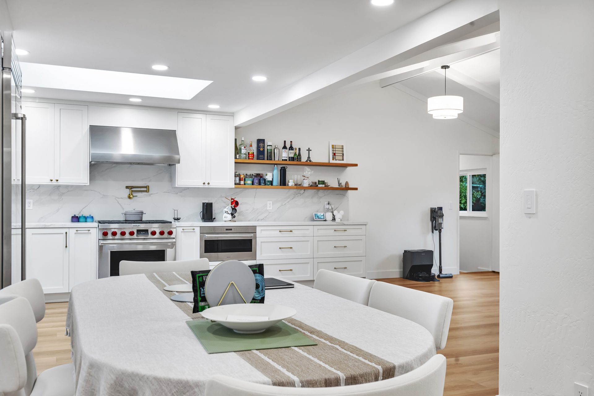 White shaker kitchen remodel with quartz countertops and open wood shelving